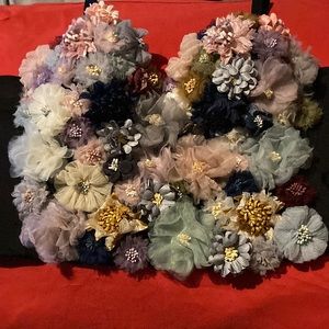 A 3D flower top from AKIRA in a size large and the colors black,pink,blue.